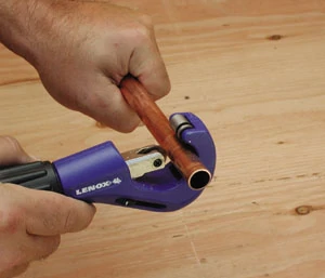 While copper pipe can be cut with a hack saw, a much better cut will be made with a pipe cutter.