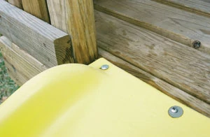 Fasten the slide to the deck with the included hardware.