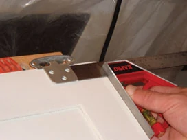 Use a combination square to make sure you keep the hinges and handles consistently spaced when installing the hardware.