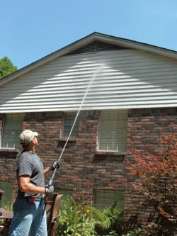 The Ladder-Saver nozzle shown adds 40 feet of reach to the pressure washer's stream.
