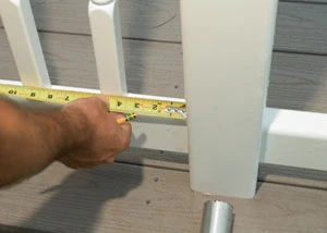 Measure the distance between the end baluster and the newel. Keep this measurement consistent throughout the rail system.
