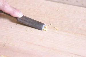 Cut away excess glue with a sharp chisel