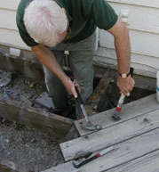 Remove the decking carefully so that you don't inadvertently damage the underlying structure. By using a crowbar and cat's paw instead of a reciprocating saw, much of the 2x6 decking was salvaged for other projects around the yard.