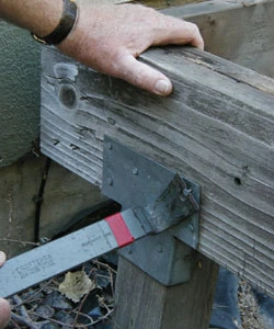If a beam appears cracked or severely rotten, it should be removed and replaced with pressure-treated wood. Carefully pull out nails before prying out bad boards so that you can simply drop in its replacement.