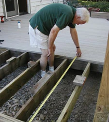 Measure the "to go" distance every so often to make sure that your decking is perfectly perpendicular to your joists. Minor adjustments made on a few planks can invisibly correct wayward boards.