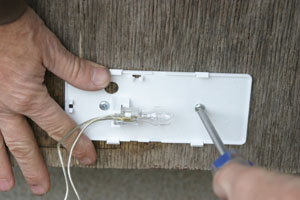 The first step is to fasten the backing plate into place.