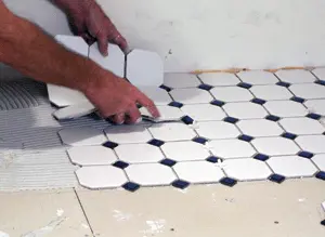 It may help to use plastic tile spacers to keep grout joints consistent.