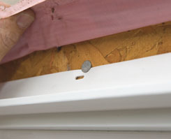 A nail just above the flange kept the window from tipping out while we checked out the alignment with the doors.