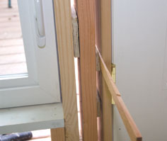 We hung the doors using cedar shingles as shims to make the minor adjustments to get them operating correctly.