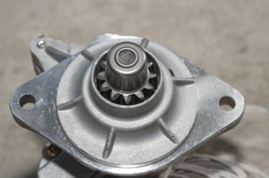 This pinion gear at the end of the starter shaft is what meshes with the ring gear on the flywheel or flex-plate.