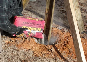 Quikrete Fast-Setting Concrete can be poured easily into the post hole dry. No mixing is required.