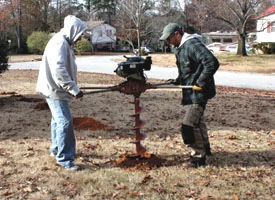 A rented two-man power auger and an electric demolition hammer helped greatly when digging the holes.