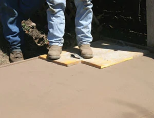 Once the concrete is sturdy enough to support a person and the stamps, the stapms are applied. In most instances you will need enough stamps to go across one end of the pour. Postion one stamp following the manufacturer's instructions.