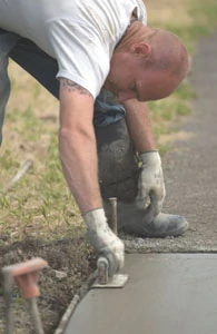 The bullnose shape of an edge trowel helps release the forms, which are removed earlier than usual for washing.