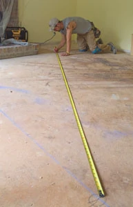 Take time to establish some layout lines before beginning the hardwood floor install.