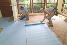 Roll out the foam backer pad perpendicular to the directin that your flooring will be installed.