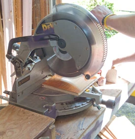 A miter saw with enough cut width is the right tool to cut engineered hardwood flooring to length.