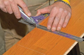 Use masking tape on the base of the jigsaw to guard against scratches on the prefinished flooring.