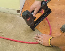 We trimmed the existing carpet to match the flooring transition and tacked the carpet into place wit ¼-inch crown staples.