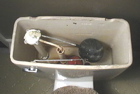 Shown is the old ballcock valve, which we removed and replaced.
