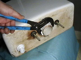 Use Channellock pliers to remove the large flush valve nut. Use a degreaser to help wipe away any grime.