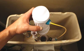 Reattach the flush valve to its base, locking it in place with a quarter turn.