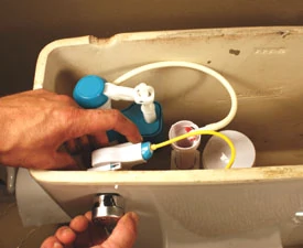 Clip the fill line to the overflow tube of the flush valves, and then screw the flush handle in place.