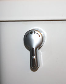 The One2Flush system uses a handle. Flip to the left for a quick flush, to the right for a full flush.