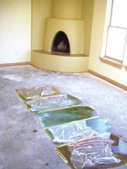 Stain samples are shown in a bedroom which is slated to receive carpet. The plastic is a texturing device used with some colors.