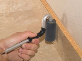We use a small roller to press the laminate onto the backsplash.
