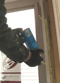Caulk the window edges, and use low-expanding foam insulation between the sleeve and framing.