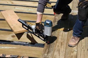 A pneumatic framing nailer with ring-shank nails can make quick work of installing a pressure-treated deck.