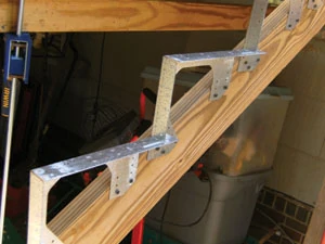 Metal stair brackets from GOPro Construction make it possible to build a staircase with minimal marks and cuts (www.goproconstruction.com).
