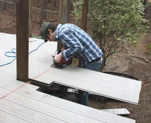 We ran the deck boards long and cut them all at once after installation was complete.