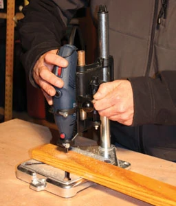 The ToolStand from Milescraft configures a Dremel-style rotary tool as a drill press for precise repetitive drilling.