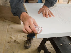 Use a sanding block to shape a slight chamfer all the way around the bottom of the door.