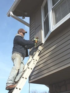 The urethane shutters are light enough for one man to install. Just zip in a couple of screws at the top to support the weight, and that's enough to hold the shutter in place while you finish the installation.