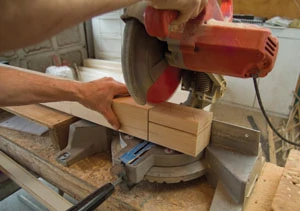 A 10-inch miter saw was used to carefully extend the horizontal shoulder cuts down to the vertical tenon cuts.