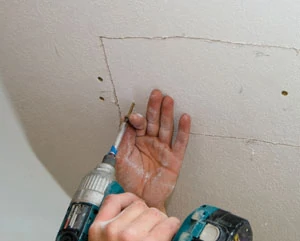 Once the backer board is anchored in place on both sides of the drywall opening, you can put the same piece of drywall back into position.