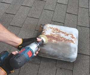 Sand away rust on metal roof fixtures and coat with an oil based metal primer.