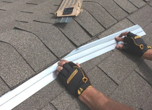 Zinc strips installed over asphalt shingles can protect the roof from algae stains.