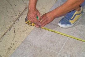 Cut the vinyl about one inch extra all the way around. Pay attention to the best locations for full pattern squares as you should with tile floors.