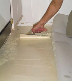 Use a trowel to spread the vinyl adhesive.