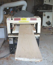 Before using for construction, the dried lumber must be shop-milled. A power planer, such as the Woodmaster shown, is used for surface and thickness planing.