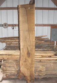 Sawing your own wood allows you to produce big slabs for table tops.
