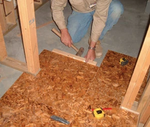 Use a RotoZip or jig saw to make small cuts. Shown here, the installer is fitting a notched panel around a wall.