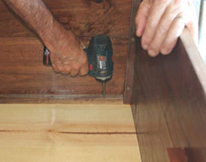 Cut the bottom and fasten it in place with hardwood cleats.