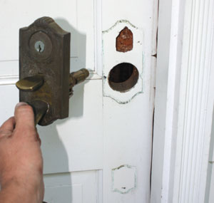 The old door handle had an integrated key, which left an ugly key hole in the door surface that we would have to fill and paint. Shown is the new Addison Handle-set from Schlage.