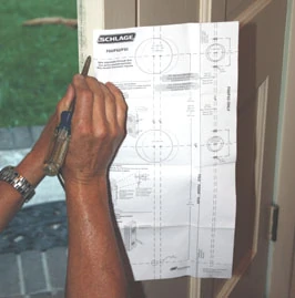 Schlage includes a paper template to help locate the holes for the door hardware.
