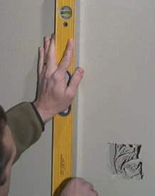 Use a level to mark the vertical lines plumb and the horizontal line level.